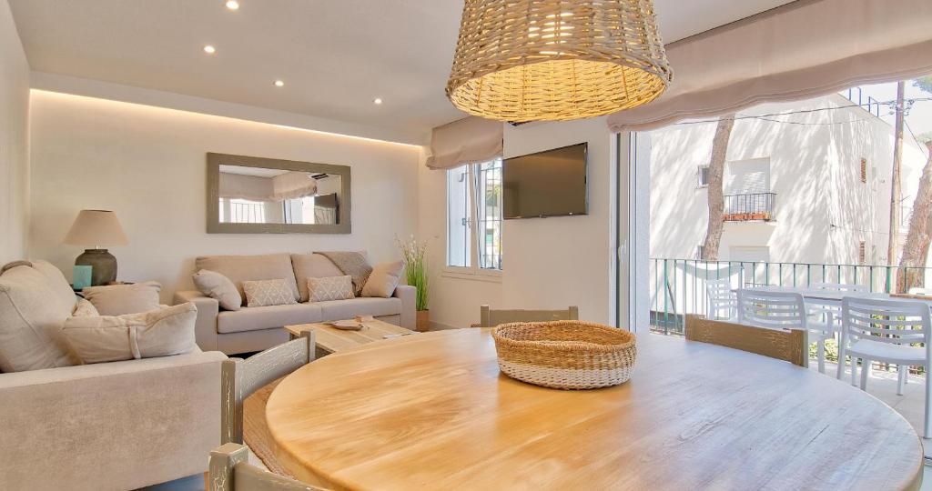 a living room with a table and a couch at Llafranc Centre, Totally Refurbished in Llafranc