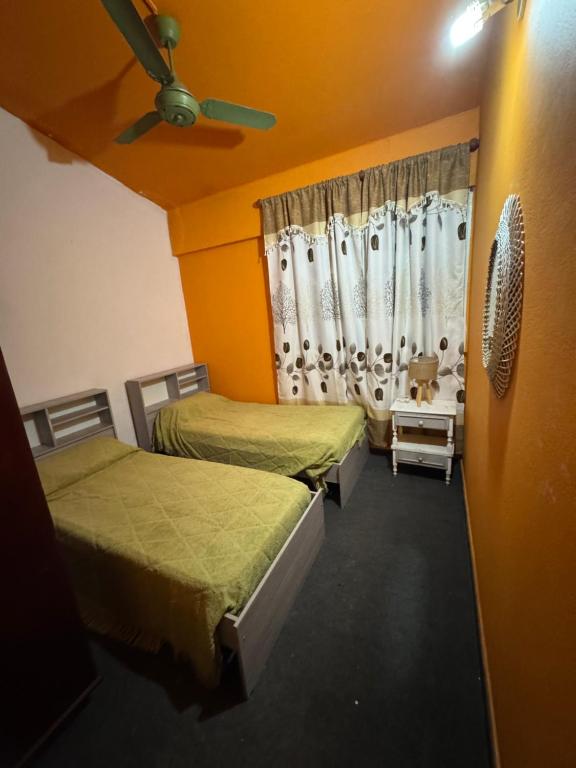 a room with two beds and a window at La Mary duplex in Federación
