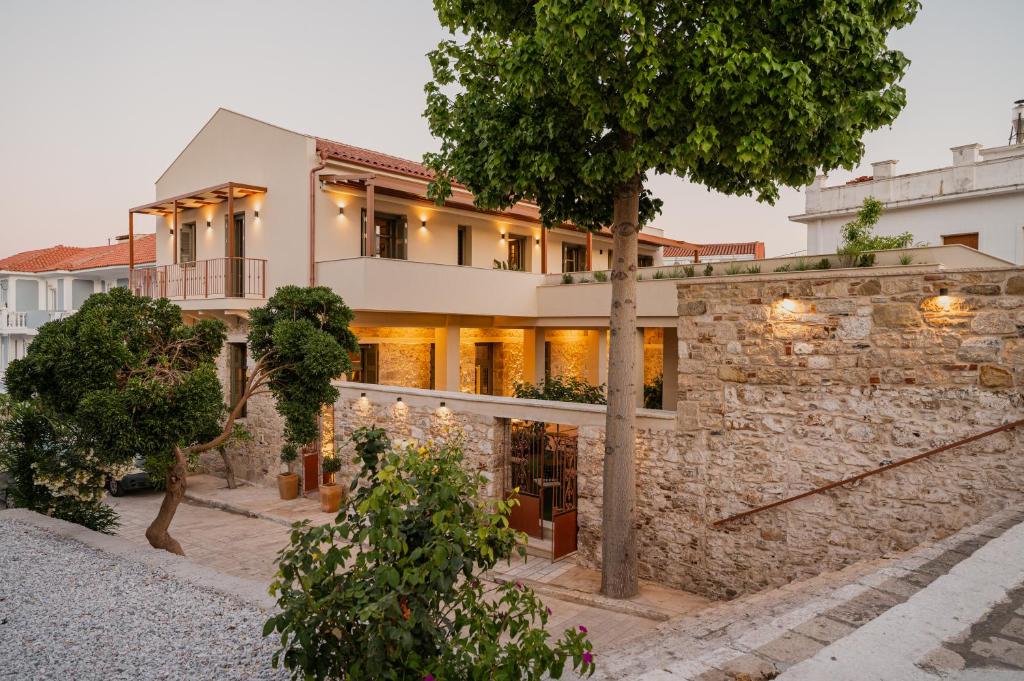 a house with a stone wall at JUNO Collection Residences in Pythagoreio