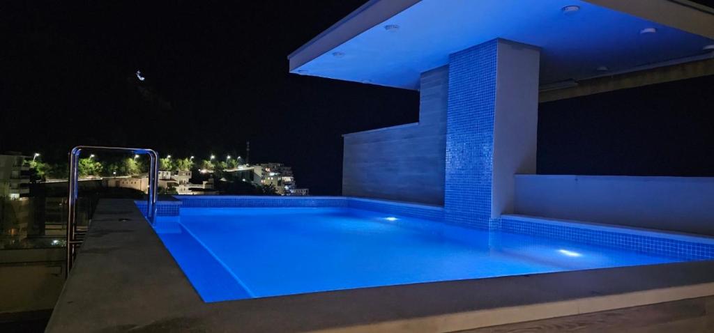 a large swimming pool on a building at night at Lux Apartment Vidovic II in Rafailovici
