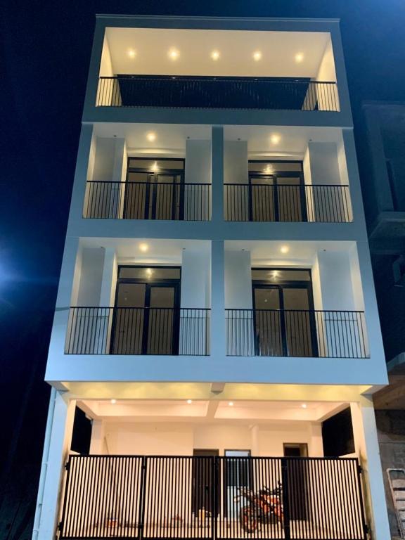 a white building with two balconies on it at Twin Tag Residency in Chennai