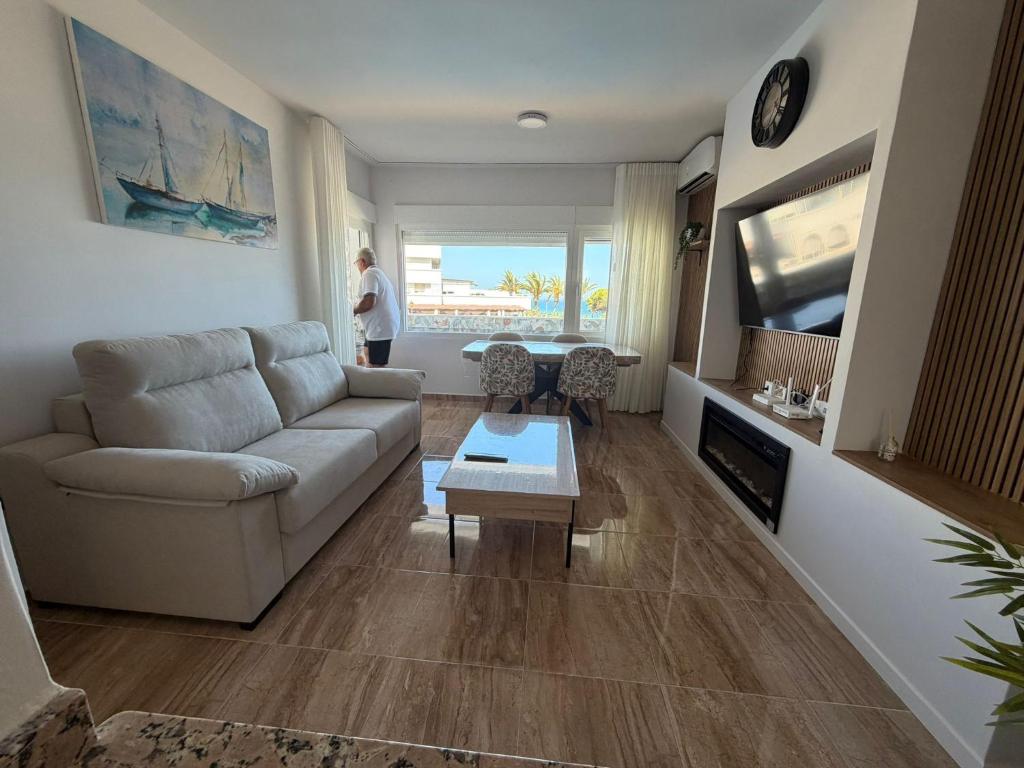a living room with a couch and a table at Espejo del mar in Mojácar