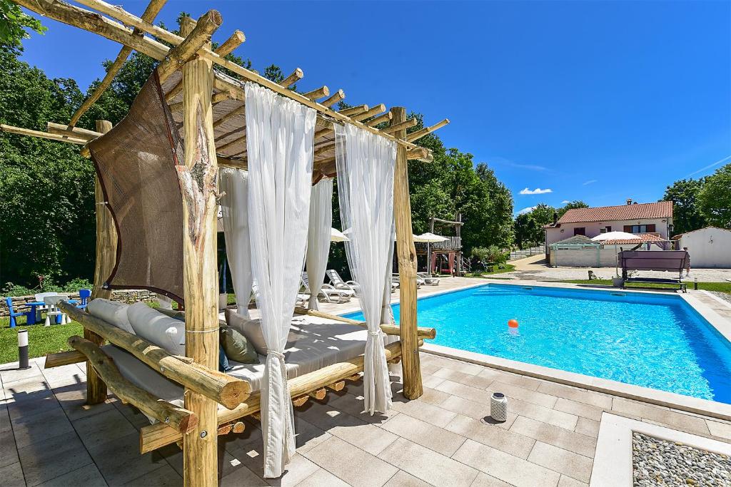a gazebo next to a swimming pool at Apartment Modrusani 1561 in Žminj