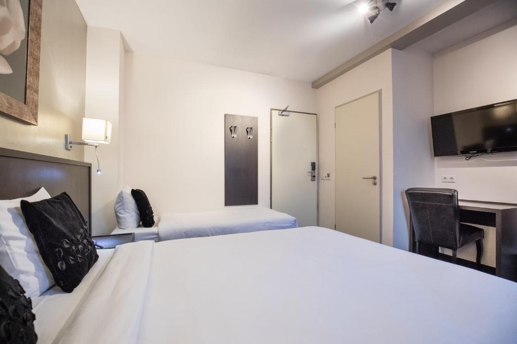 Postel nebo postele na pokoji v ubytování Hotel de Duif Lisse - Keukenhof