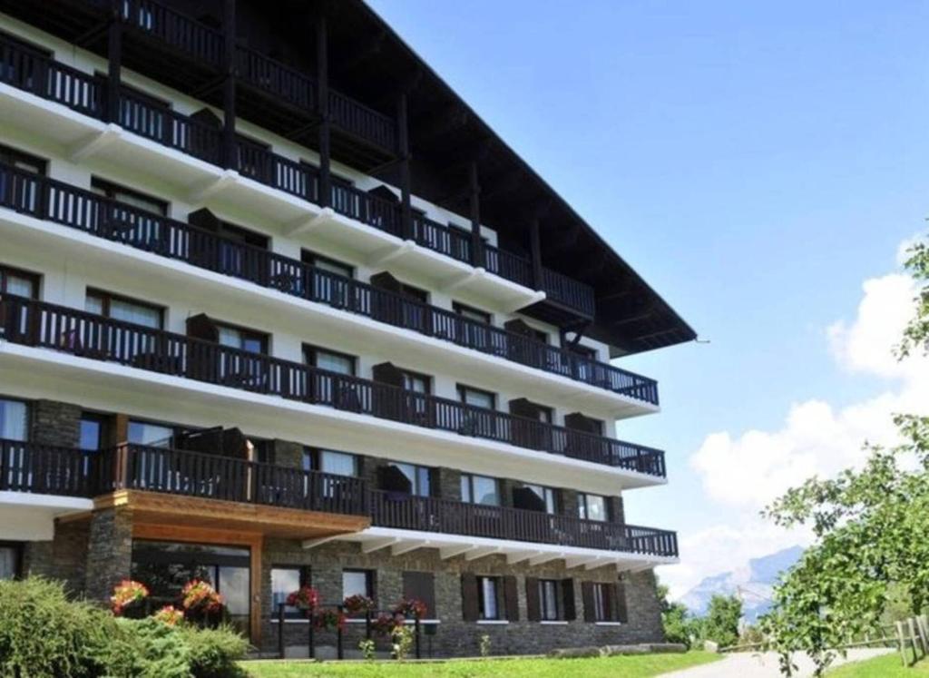 a building with balconies on the side of it at Résidence La Grande Cordée - Combloux in Combloux