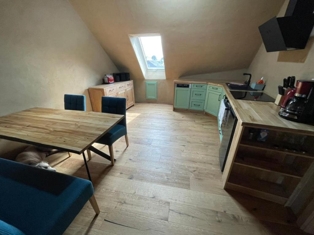 a kitchen with a wooden table and a wooden floor at Erbeskopf Gipfelquartier in Morbach