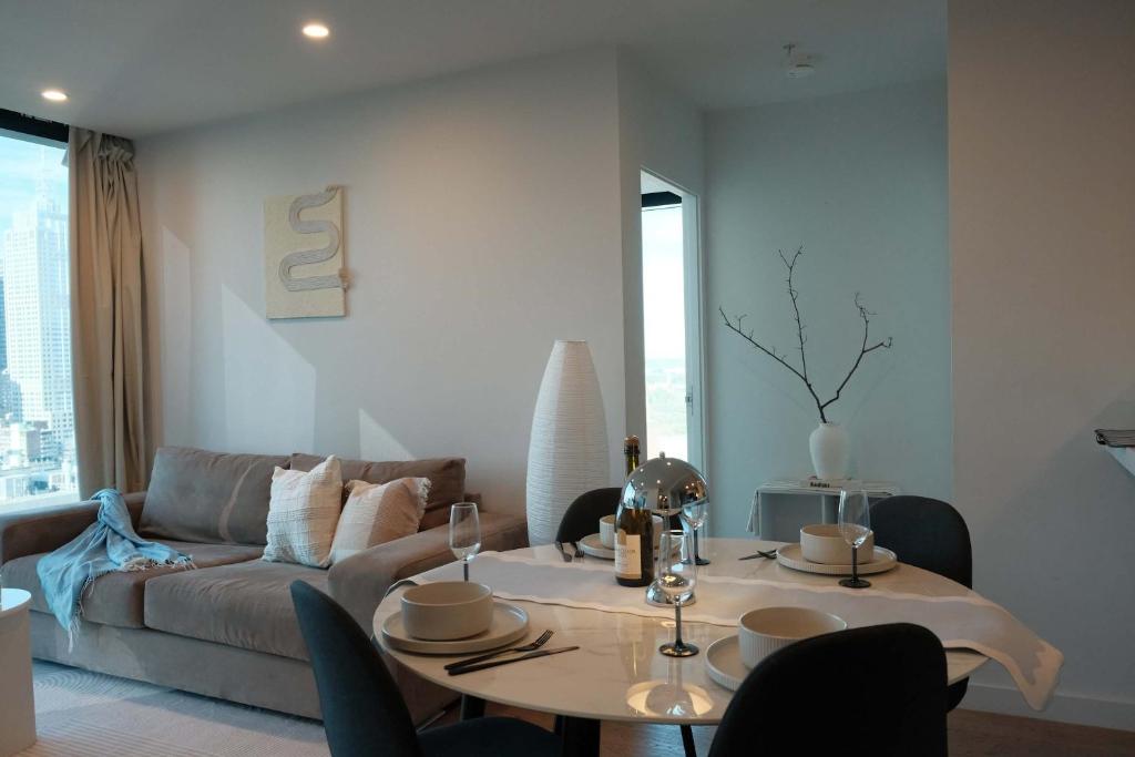 a living room with a table and a couch at Premium 3BR CBD Apt Prime Location in Melbourne