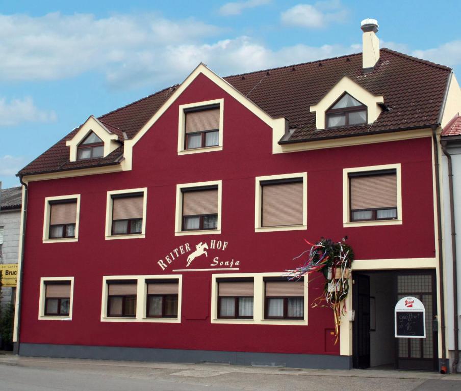 a red building with the words miracle inn on it at Reiterhof Sonja in Apetlon