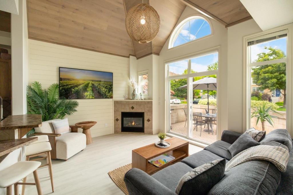 a living room with a couch and a fireplace at sunset 101 in Kelowna