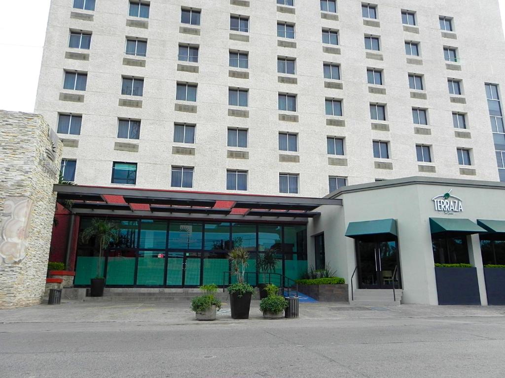 a large white building with a hotel at Hotel El Sembrador in Guasave