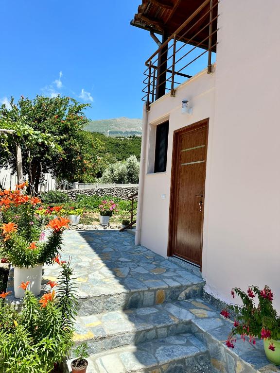 a front door of a house with flowers at Magnus Appartments in Dukat