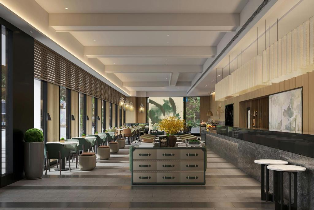 a lobby of a hotel with tables and chairs at Yong Le Lukang, a Tribute Portfolio Hotel in Lukang
