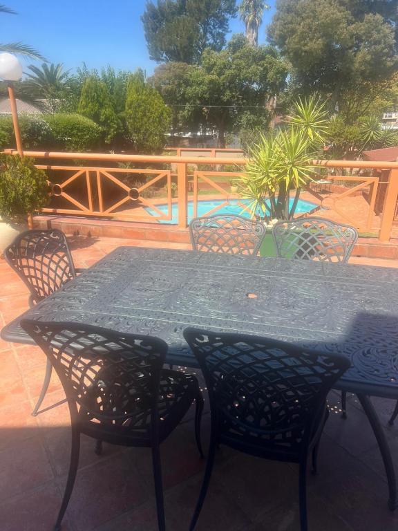 a black table and chairs on a patio at Executive Serviced Home in Johannesburg