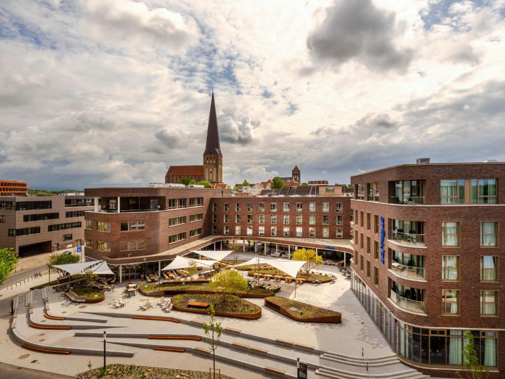 an aerial view of a city with a church at ScanHotels Stadthafen in Rostock