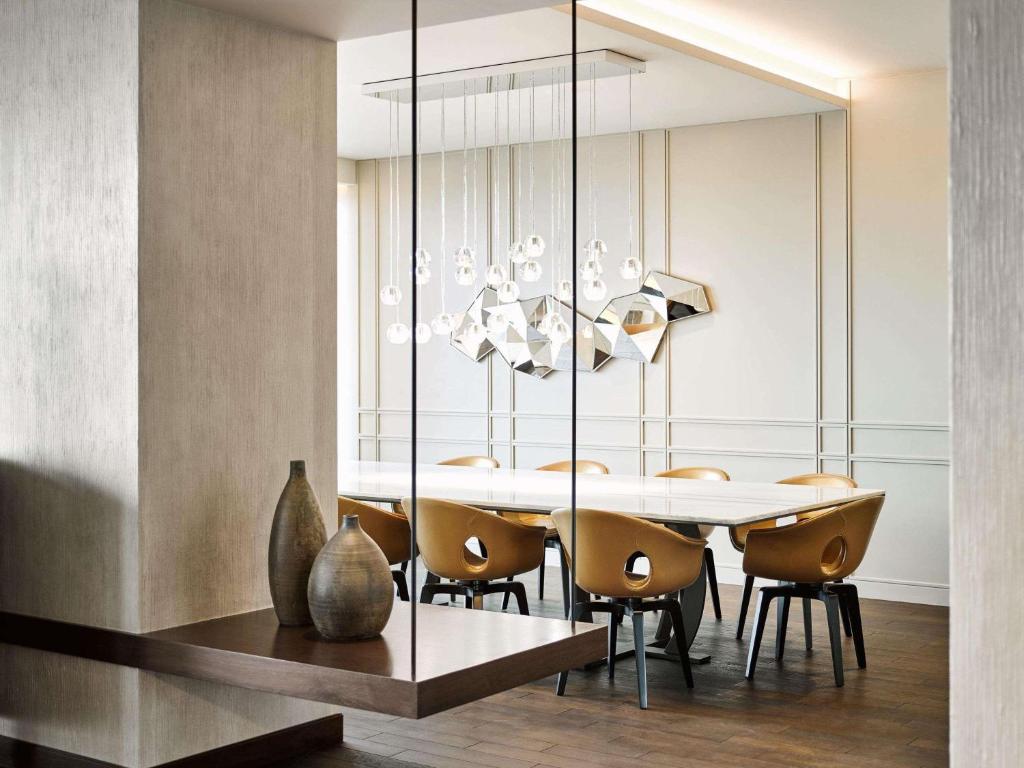 a dining room with a table and chairs at Fairmont Quasar Istanbul Hotel in Istanbul