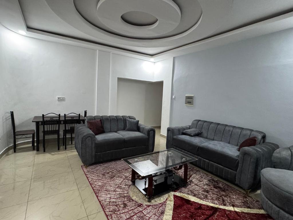 a living room with two couches and a table at Mitty Residence in Conakry
