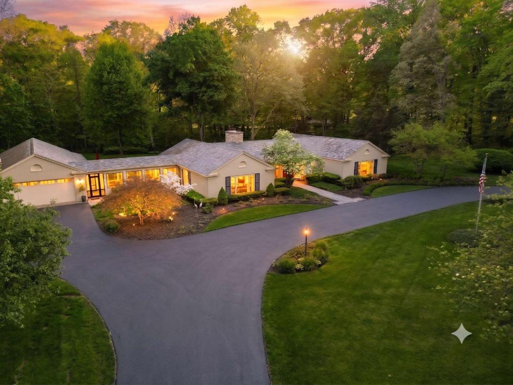 an aerial view of a house with a driveway at Audubon Acres l pool table & outdoor dining in Benton Harbor