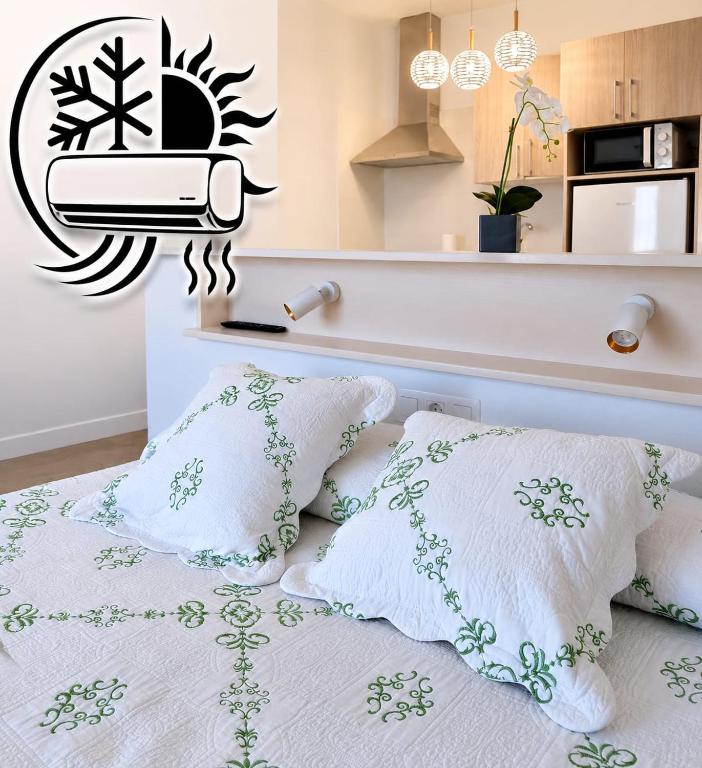 a bedroom with a bed with pillows and a toaster at Apartamentos Los Volcanes in Fuencaliente de la Palma