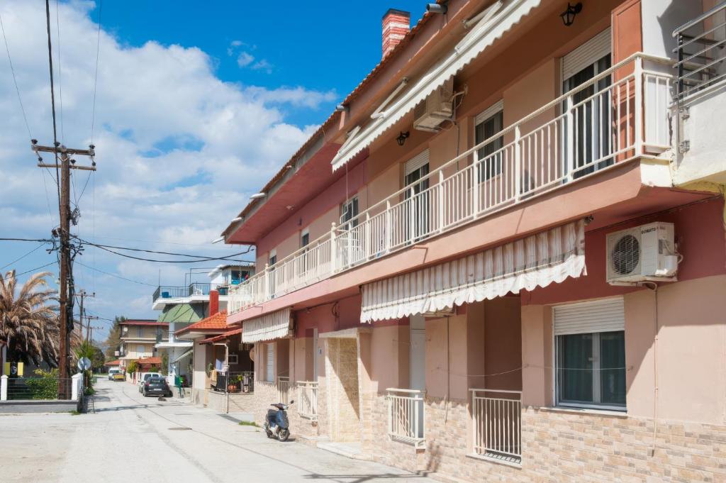 a street in a town with a pink building at Irini rooms Olympiada in Olympiada