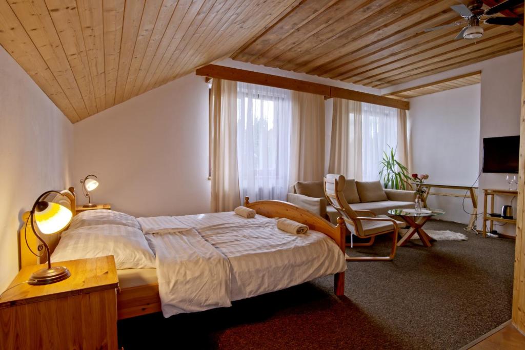 a bedroom with a large bed and a living room at U Certa in Čerčany