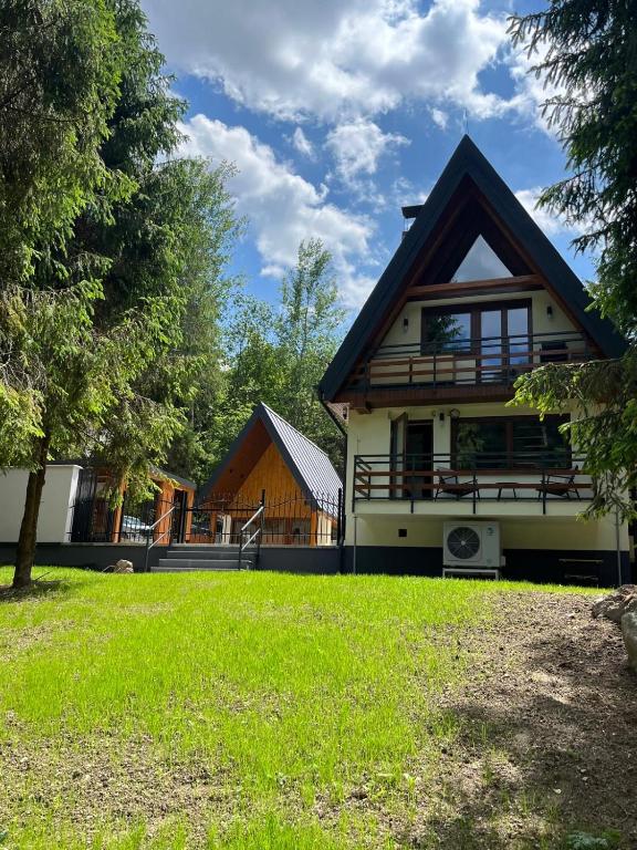 a house with a green yard in front of it at Green-in in Jaklovce
