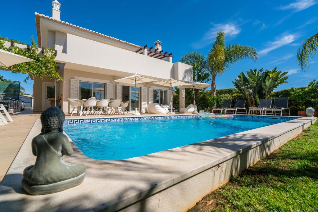 a villa with a swimming pool in front of a house at Casa Eleonora lifestyle Lodge in Lagos