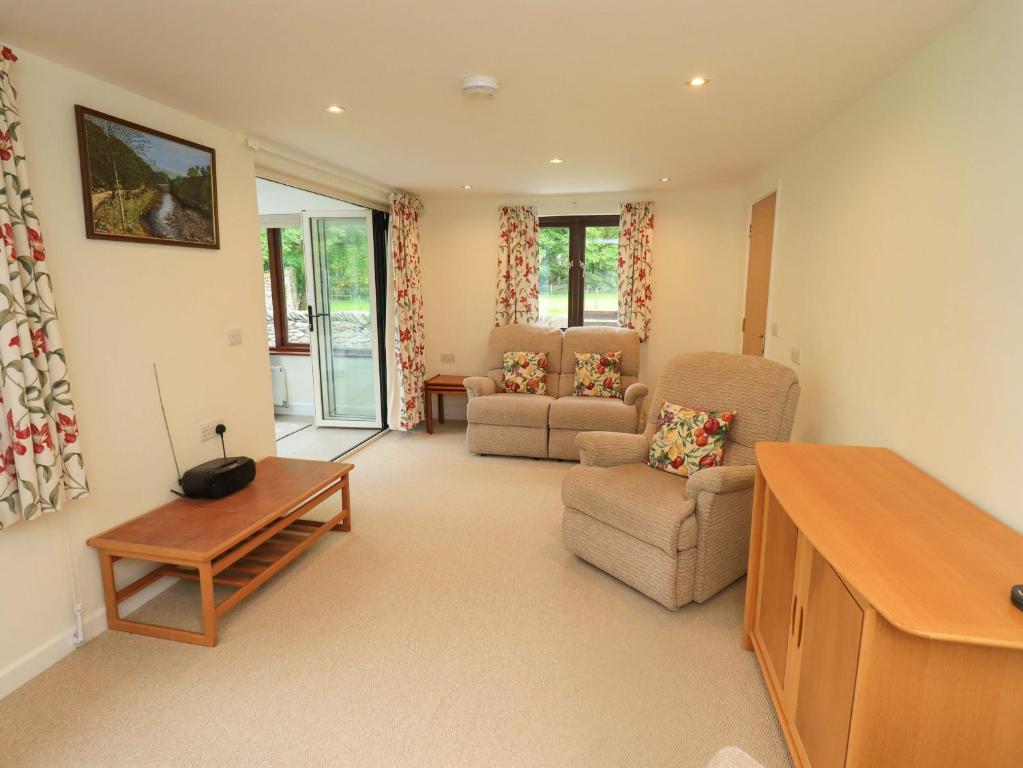 a living room with a couch and a table at Rowanberry Cottage in Grasmere