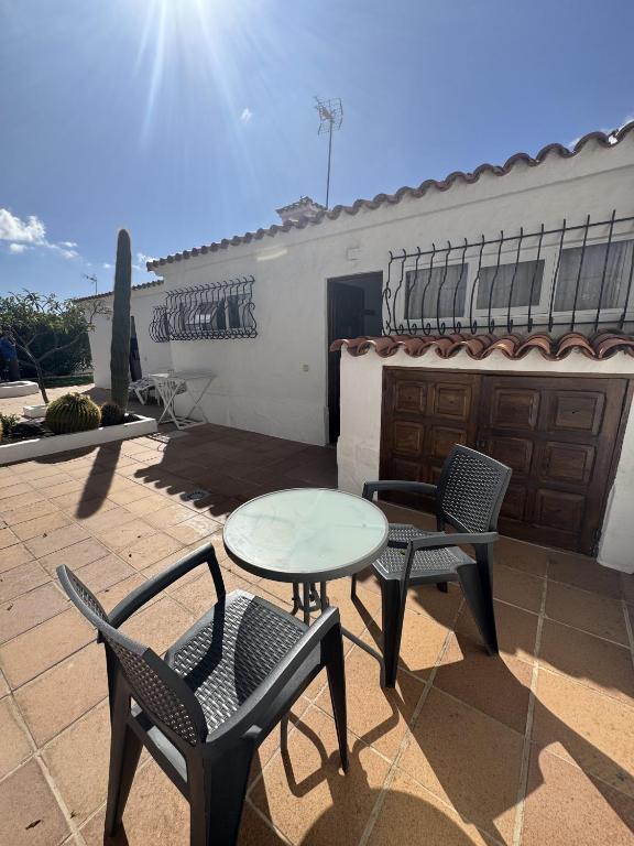 a patio with two chairs and a table and two chairs at Los Porches K28 in Playa del Ingles
