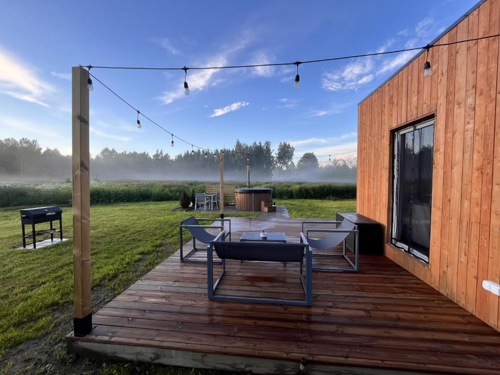 a wooden deck with a table and chairs on it at Napu Puhkemaja in Rabivere