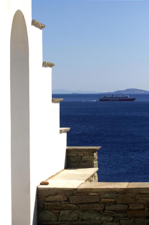a view of the ocean from a building with a cruise ship at Rosalie Home - Open Sea Studio in Tinos