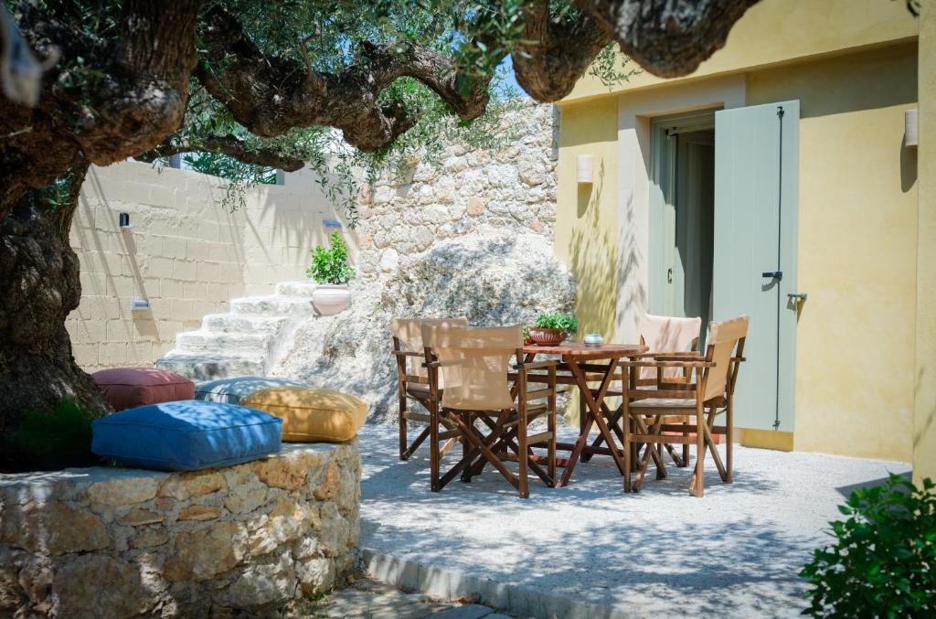 a table and chairs sitting outside of a building at Limni house in Kythira