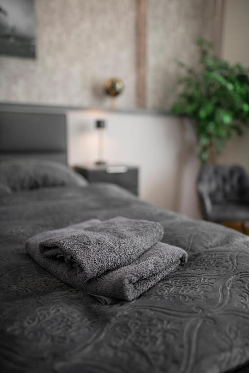 a bed with two towels sitting on top of it at FeWo LUNA in Riesa