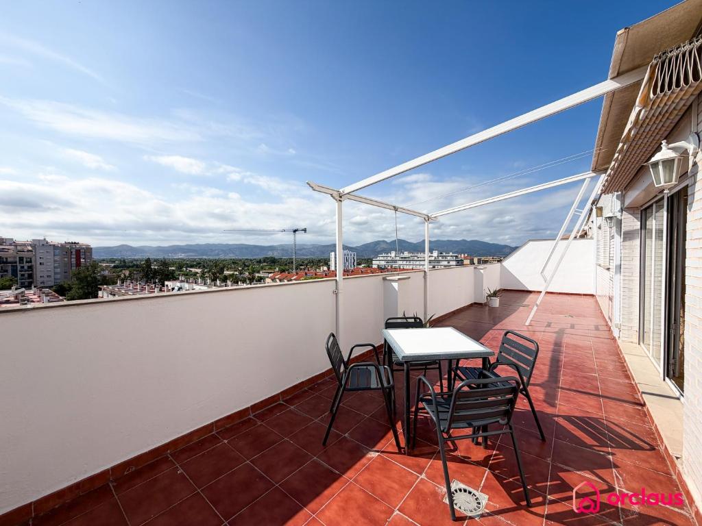 a balcony with a table and chairs on a building at The Skyline in Grao de Castellón