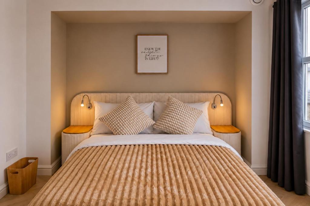a bedroom with a large bed with two pillows at Luxe By The Sea - Luxury in the Centre of Brighton - Aparthotel - 3 Beautiful Apartments - Penthouse Available in Brighton & Hove