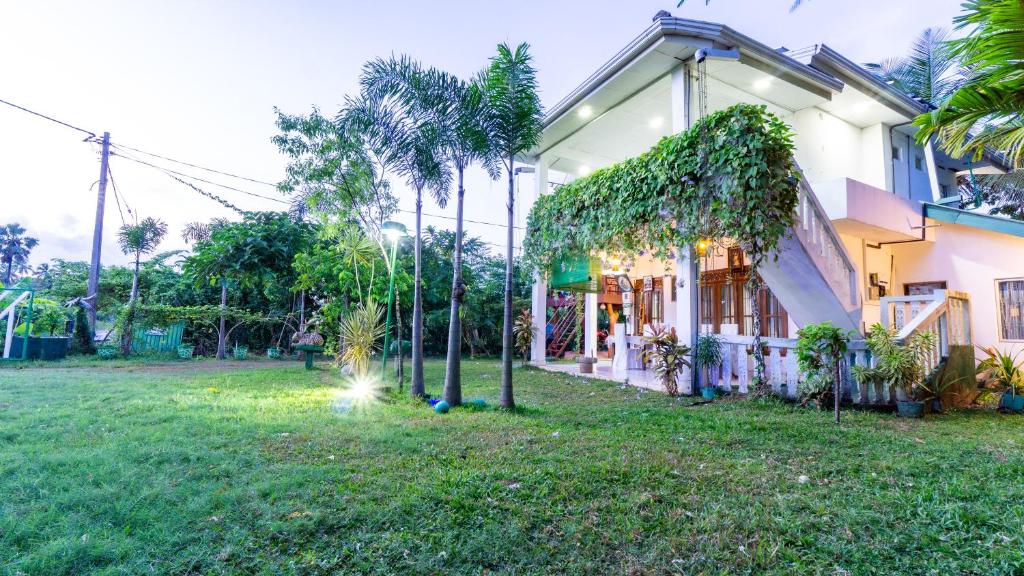 a house with a green yard in front of it at lake Edge Dambulla in Dambulla