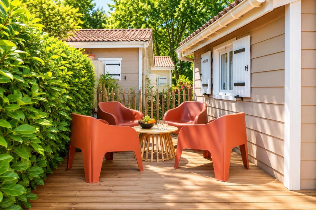 a group of chairs and a table on a patio at Chalet l'Escale du Cèdre in Rivières