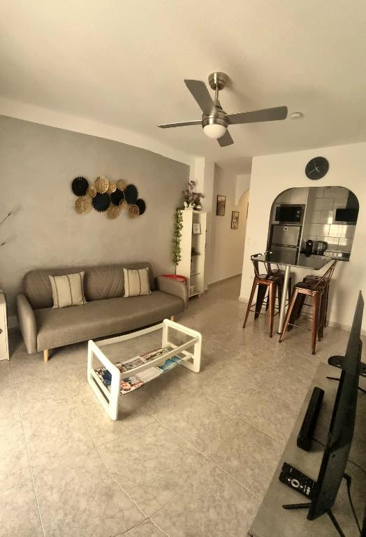a living room with a couch and a table at AYAHAY, Modern luxury apartment just 50 m from Playa Del Puerto in Puerto de Mazarrón
