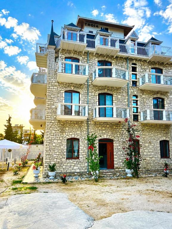 a building with balconies on the side of it at The White Troy in Sarandë