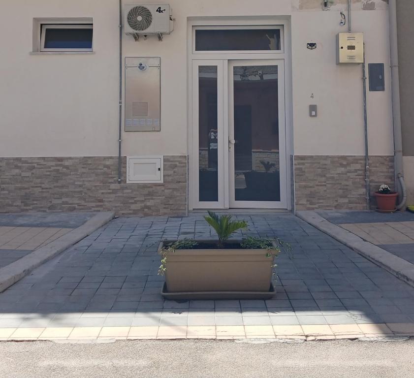 a plant in a pot in front of a building at A Casuzza in Balestrate