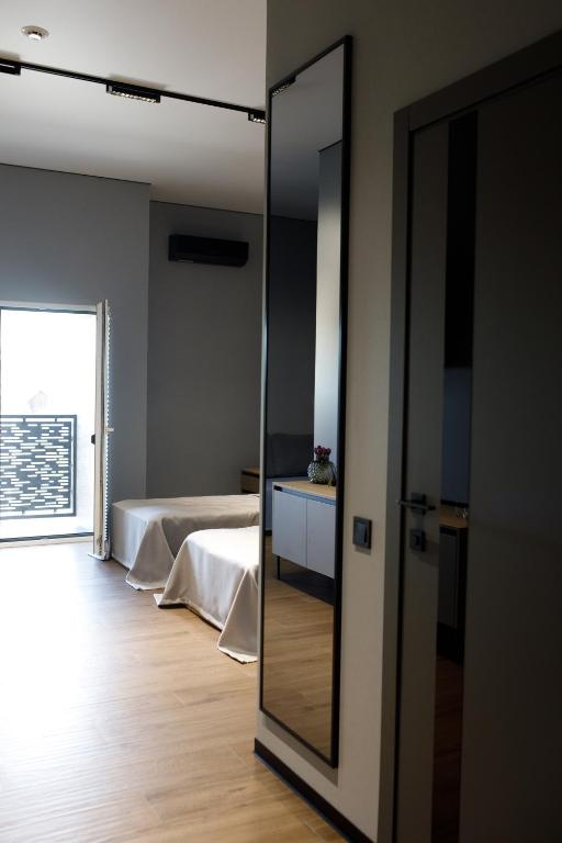 a room with a bedroom with a mirror and a bed at Готель «ТАВЕРНА» in Ovruch