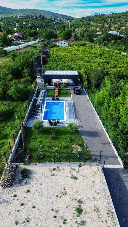an overhead view of a house with a swimming pool at Villa Mali Raj in Čapljina