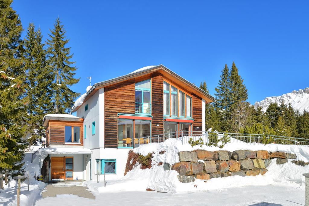 a log home in the snow with trees at Golden Peaks Ferienhaus Valbella-Lenzerheide in Valbella