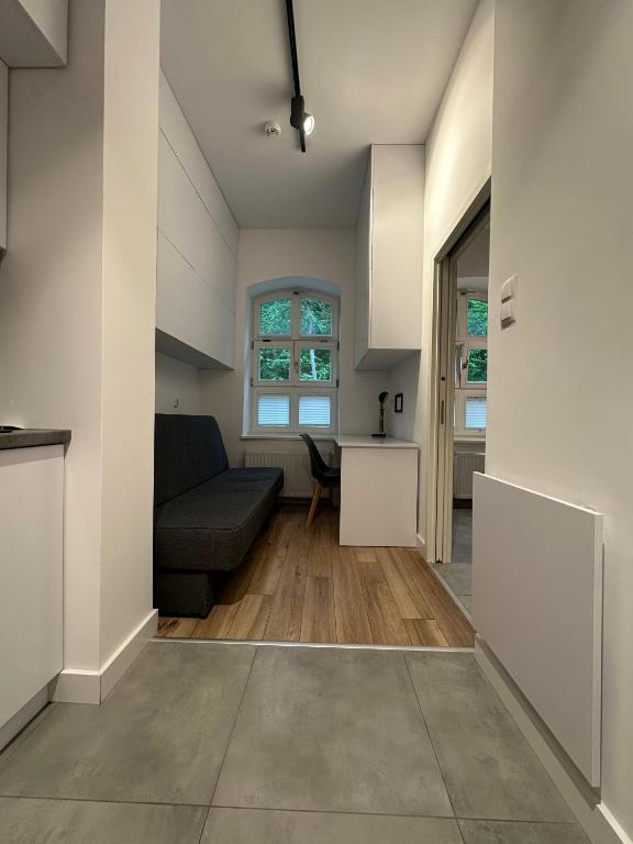 a living room with a couch and a table at Apartament Gdański Harward lokal nr 2 in Gdańsk