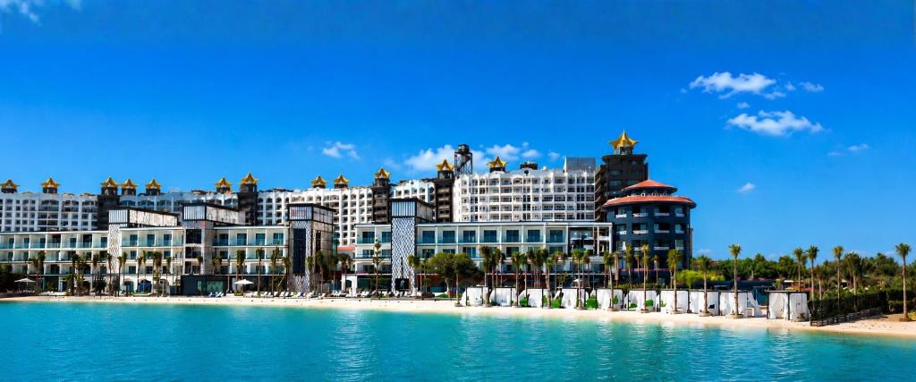 a large building on the beach next to the water at M Hotels at Porto Marina in El Alamein