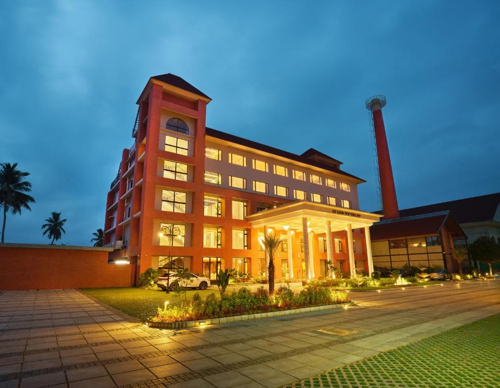 a large brick building with a smoke stack at JP Crowne Regency in Pullappalli
