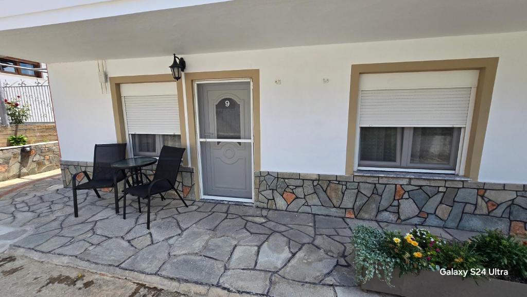 a patio with a table and chairs in front of a house at studios ELENA in Potos