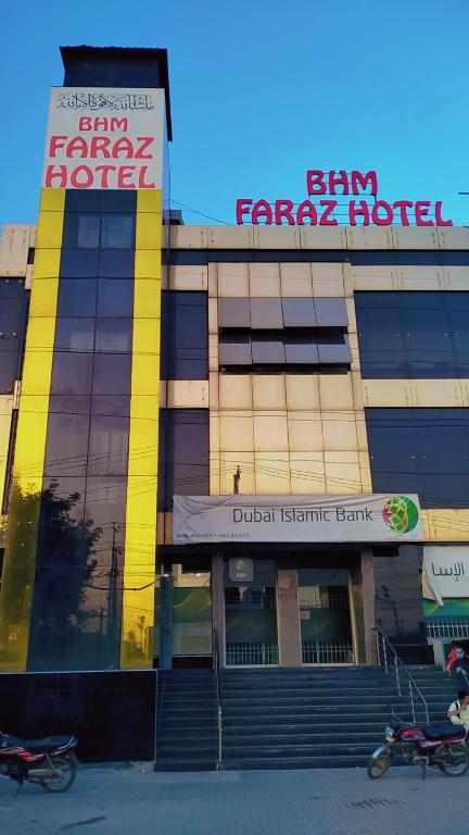 a building with two motorcycles parked in front of it at BHM Faraz hotel in Theri Sānsi