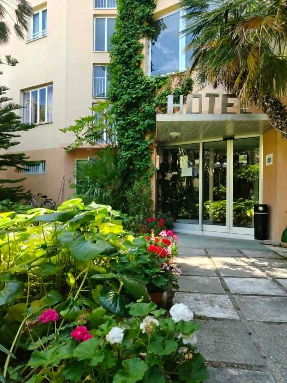a hotel with flowers in front of a building at Hotel La Terrazza in Porto San Giorgio