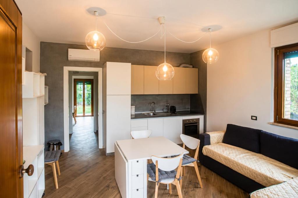 a living room with a couch and a table at Smart Suite at Villa Anna - Bike Friendly in Buonconvento