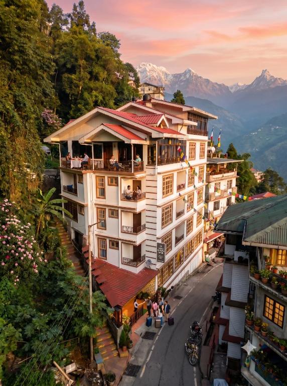 an overhead view of a building with mountains in the background at ANG'S Retreat By WINGS Expolores in Gangtok